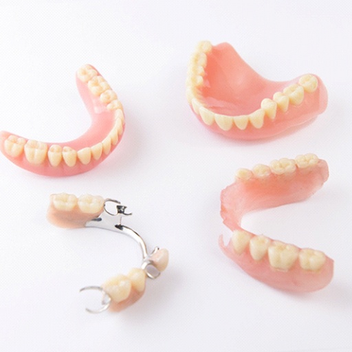 Different types of dentures on white background