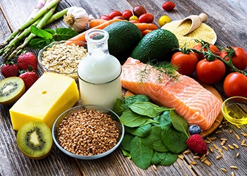 Variety of wholesome foods gathered on wooden tabletop