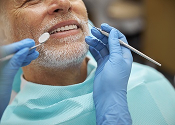 Nose-to-shoulder view of man about to undergo dental exam