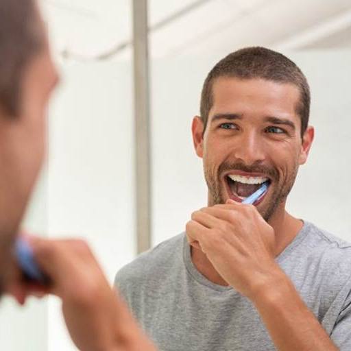 Man brushing his teeth to prevent dental emergencies in Winfield