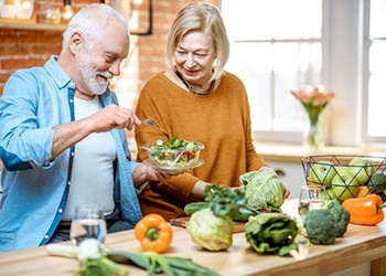 an older couple preparing a healthy meal